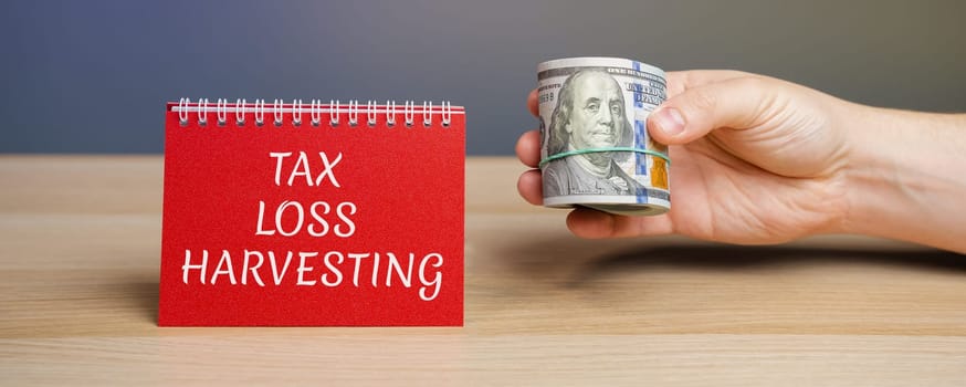 Notes with the Tax loss harvesting. Timely selling of securities at a loss to offset the amount of capital gains tax owed from selling profitable assets. Business and finance concept