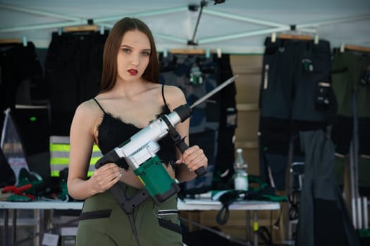 A confident model elegantly showcases striking and fashionable equipment against a vibrant fashion backdrop