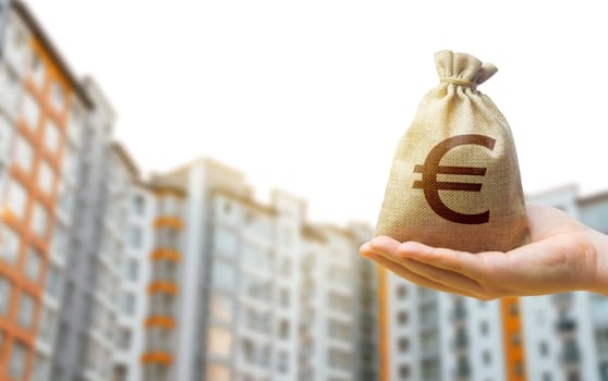 Euro bag against the background of modern high-rise buildings. Investing in the purchase of real estate. Affordable housing and mortgage rates. Renting apartments and houses. Blurred background