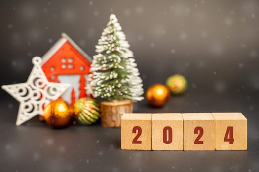 Blocks 2024, Christmas tree and red house. Merry Christmas and Happy New Year! Xmas concept. Festive winter holiday. Snowfall