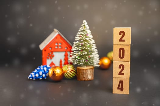 Blocks 2024, Christmas tree and red house. Merry Christmas and Happy New Year! Xmas concept. Festive winter holiday. Snowfall
