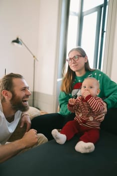 A joyful and cheerful family is happily enjoying a playful and delightful moment together with their baby
