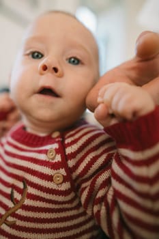 An adorable closeup of a cherubic baby with a curious expression, playfully interacting with the world