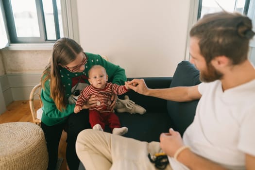 A joyful family moment with parents playing lovingly with their adorable baby in a cozy living room