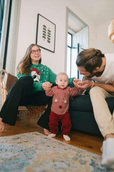A joyful family scene with laughter celebrating the holidays together, featuring a happy baby in a cozy setting