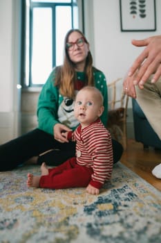 A warm and inviting scene where a parent and their baby are joyfully spending quality time indoors on a beautiful rug