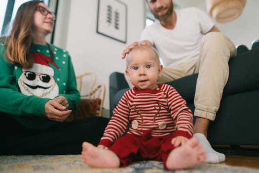 A heartwarming and joyful family moment showcasing a baby along with parents in a cozy living room setting