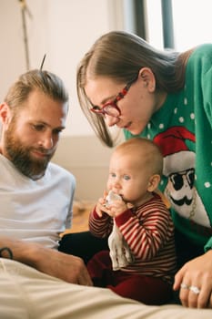 A heartwarming moment of family bonding with a happy baby and loving parents celebrating joy together