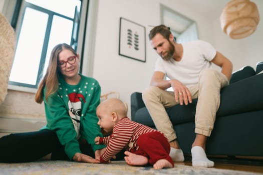 A joyful and heartwarming family scene featuring parents and their adorable baby enjoying quality time at home together
