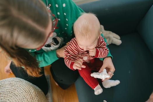 A heartwarming scene depicting a loving parent and their adorable baby fully enjoying a festive moment together
