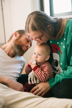 A touching scene shows loving parents adoring their baby, beautifully capturing love and togetherness