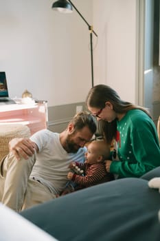 A joyful family shares abundant love and laughter, cherishing precious moments spent together with their baby
