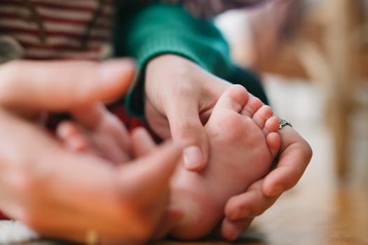 Capturing the gentle and loving touch of a parent as they nurture their childs tiny, precious foot lovingly