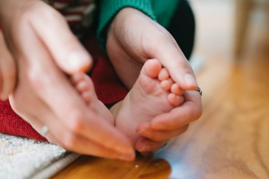 Capturing the warmth and bond between a parent and their baby through gentle touches and nurturing actions