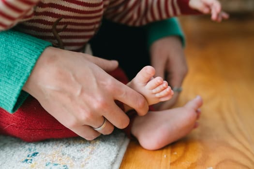 A heartwarming and tender scene beautifully showcasing a loving parent gently holding their childs tiny foot