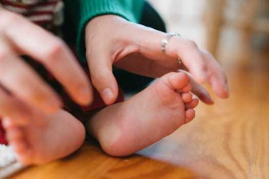 A gentle interaction between a loving parent and their babys foot, capturing pure love and connection