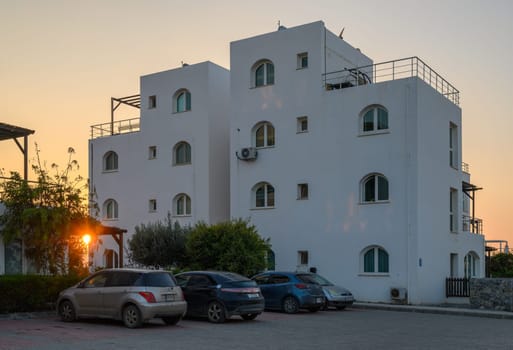 Sunlight filters through the structures as evening descends, highlighting the beauty of coastal architecture.