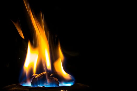Vibrant flames against dark background with intense heat and flickering light.