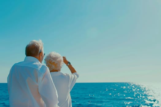 Elderly caucasian couple enjoying ocean view on a sunny day.