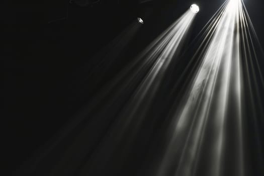 Light beams shining on stage in dark environment.