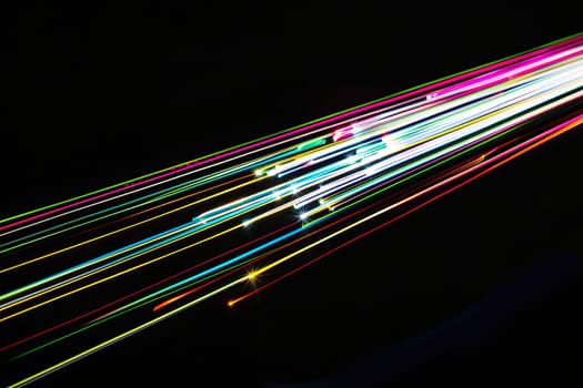 Colorful light trails on black background.