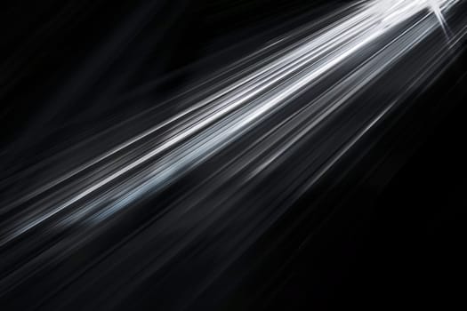 Abstract light streaks against dark background.
