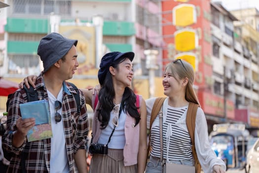 A group of young Asian friends joyfully interacting while walking through a lively market, celebrating the essence of travel and strong friendships.