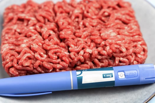 Ozempic Insulin injection pen and raw minced meat for diabetics and weight loss. High quality photo