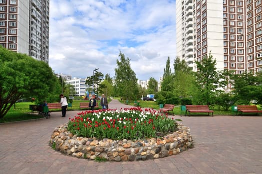 Moscow, Russia - June 1. 2022. Boulevard with the flowerbed and benches in Zelenograd