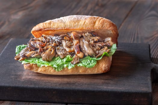 Delicious vegetarian sandwich with toasted ciabatta, fried oyster mushrooms, and yellow sauce