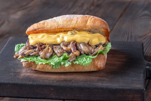 Delicious vegetarian sandwich with toasted ciabatta, fried oyster mushrooms, and yellow sauce