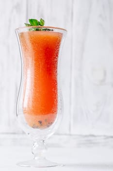 Vibrant Jamaican Me Crazy cocktail in hurricane glass, mint garnish for refreshing twist