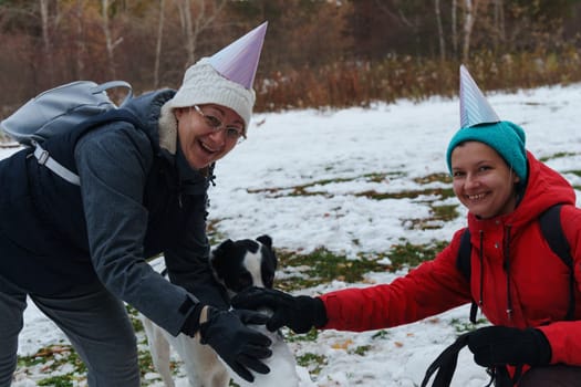 Joyful moments creating a snowman with friends in a snowy park during winter celebrations