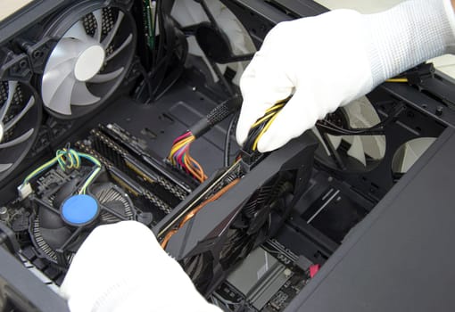 top view mechanic installing graphics card