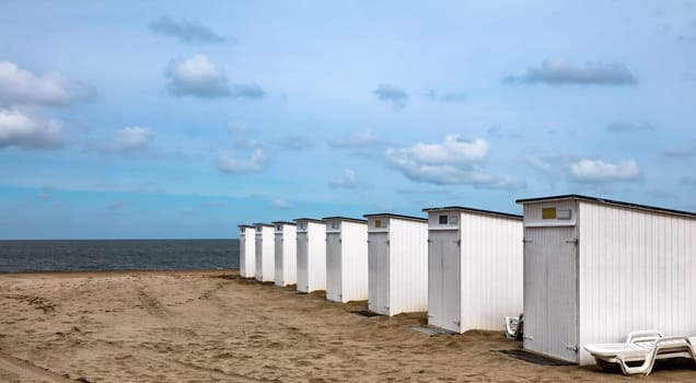 Wooden cabins on a spring beach in Belgium.