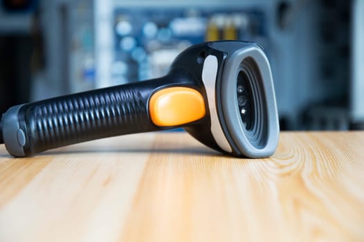 barcode scanner placed on a brown wooden floor