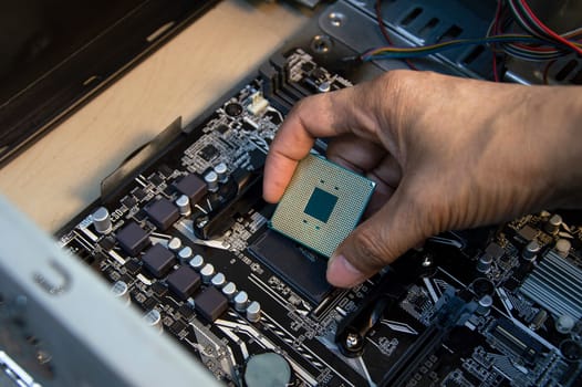 top view technician inserting cpu, computer assembler