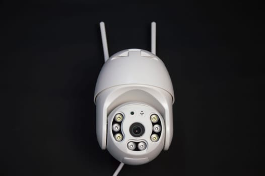 White IP camera over a black background