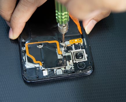 top view, mechanic repairing smartphone