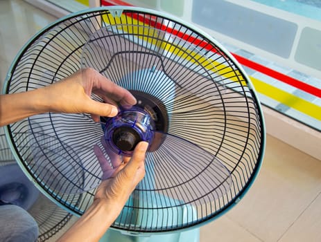 Technician repairing fan, replacing impeller