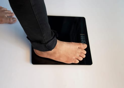 standing on the indoor scales There is space for text. The problem of being overweight or underweight