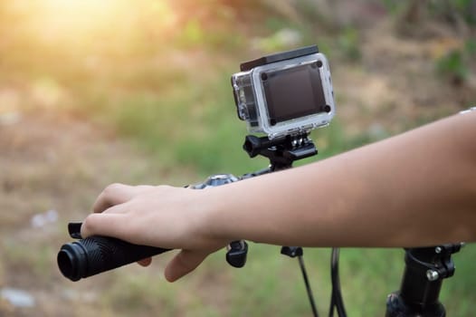 A digital camera mounted on the handlebars of a mountain bike.