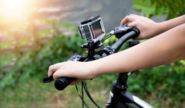 A digital camera mounted on the handlebars of a mountain bike.