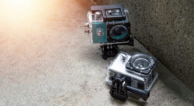 2 action cams placed on the floor, waterproof and dustproof