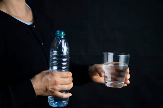 woman holding a glass of water The concept of drinking enough water every day for good health.