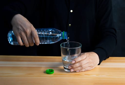 woman pouring water into glass drink water every day