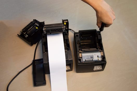 Top view. Technician repairing printer, thermal printer.