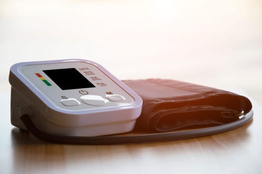 Blood pressure monitor placed on a wooden floor