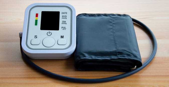 Blood pressure monitor placed on a wooden floor