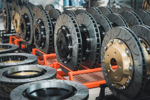 Car mechanic or serviceman disassembly and checking a disc brake and asbestos brake pads for fix and repair problem at car garage or repair shop